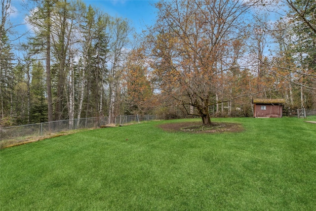 view of yard with fence and an outdoor structure