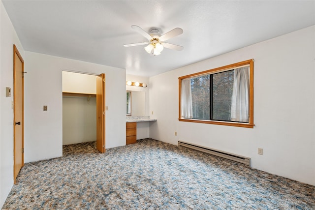 unfurnished bedroom with ceiling fan, light carpet, built in study area, a baseboard radiator, and a closet
