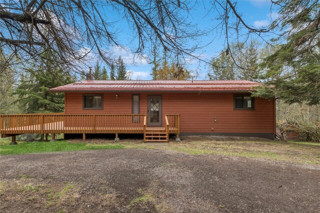 535 Reservoir Rd, Whitefish, MT 59937 - view of front of home featuring a wooden deck, a chimney, and metal roof
