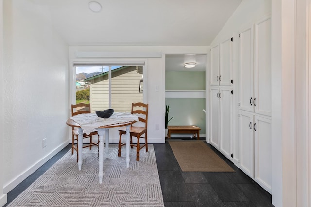 309 7th Ave W, Polson, MT 59860 - dining space featuring vaulted ceiling and baseboards