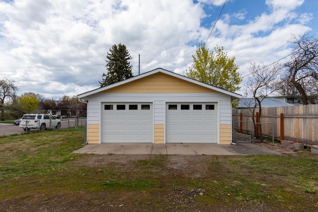 detached garage featuring fence