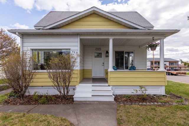 309 7th Ave W, Polson, MT 59860 - bungalow-style home with a porch and roof with shingles