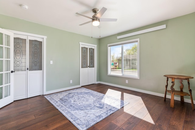 309 7th Ave W, Polson, MT 59860 - unfurnished room featuring dark wood-type flooring, ceiling fan, a smoke detector, and french doors