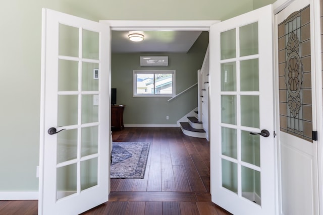 doorway to outside with french doors, wood-type flooring, baseboards, and stairway