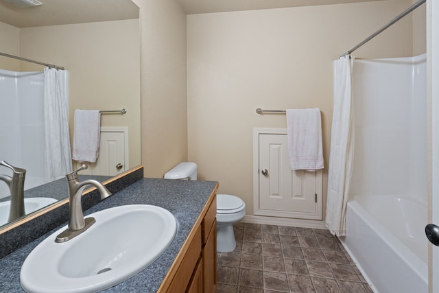 4217 Bordeaux Blvd, Missoula, MT 59808 - bathroom featuring vanity, shower / tub combo with curtain, stone finish floor, and toilet