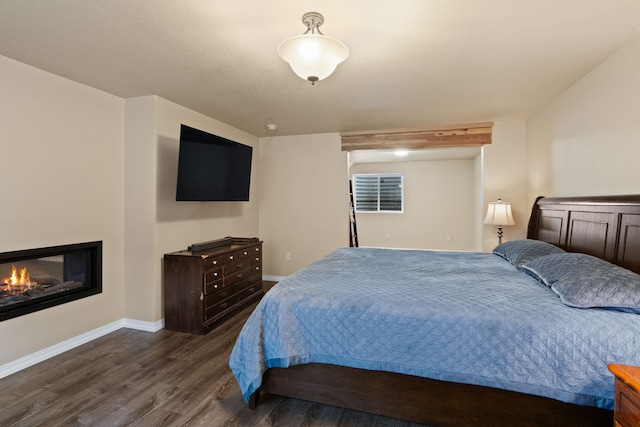 4217 Bordeaux Blvd, Missoula, MT 59808 - bedroom featuring baseboards, a glass covered fireplace, and wood finished floors