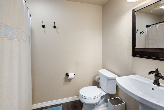 4217 Bordeaux Blvd, Missoula, MT 59808 - bathroom featuring toilet, baseboards, a sink, and wood finished floors