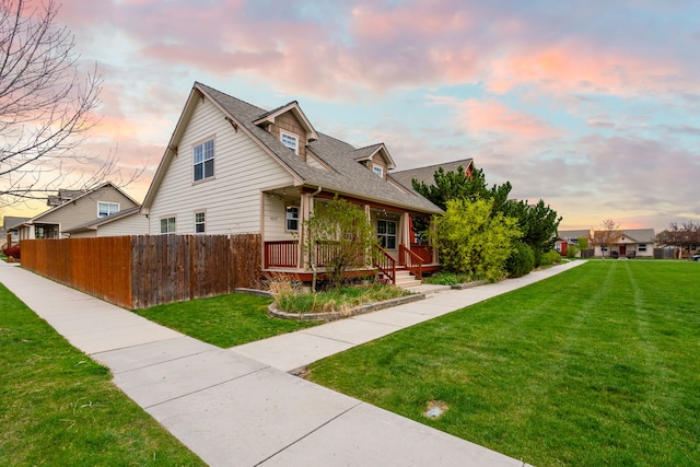 4217 Bordeaux Blvd, Missoula, MT 59808 - view of property exterior with fence, covered porch, a shingled roof, and a lawn