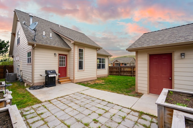 4217 Bordeaux Blvd, Missoula, MT 59808 - rear view of property with roof with shingles, central air condition unit, fence, a yard, and a patio