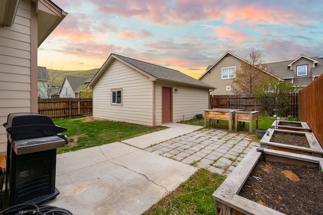 4217 Bordeaux Blvd, Missoula, MT 59808 - exterior space featuring a garden, a lawn, an outdoor structure, a fenced backyard, and a patio