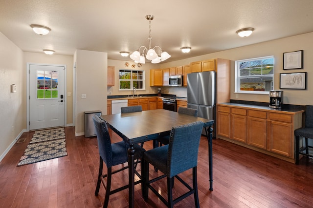 4217 Bordeaux Blvd, Missoula, MT 59808 - dining room featuring baseboards, a chandelier, and dark wood-style floors