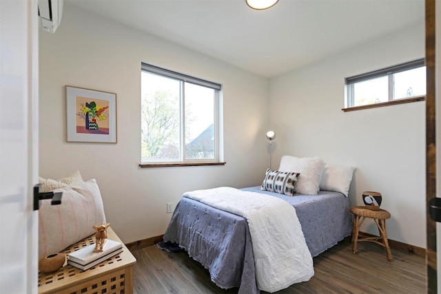 bedroom with baseboards and wood finished floors