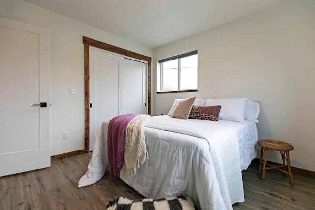 bedroom with baseboards, a closet, and wood finished floors