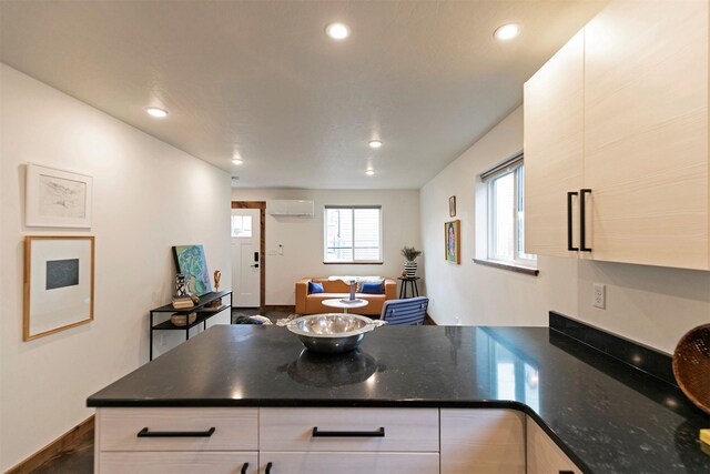 1410 S 5th St W Unit B, Missoula, MT 59801 - sitting room featuring baseboards, a wall mounted air conditioner, finished concrete floors, and recessed lighting