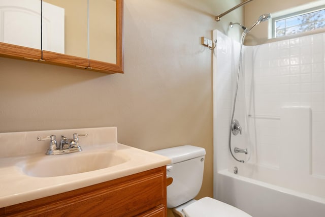 bathroom featuring vanity, shower / bathtub combination, and toilet