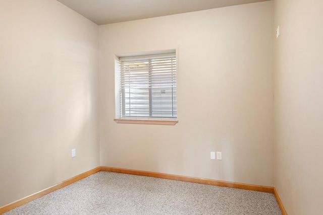 carpeted spare room with baseboards