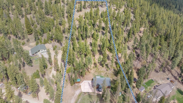 birds eye view of property with a forest view