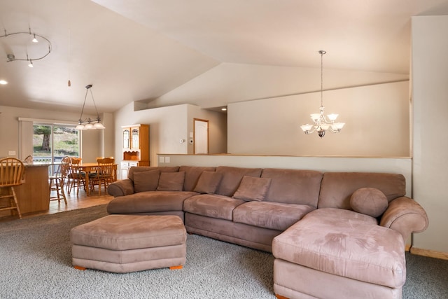 carpeted living area with rail lighting, lofted ceiling, and a notable chandelier
