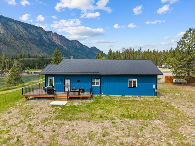 29 Shoreline Dr, Thompson Falls, MT 59873 - back of house with metal roof, a deck with mountain view, and crawl space
