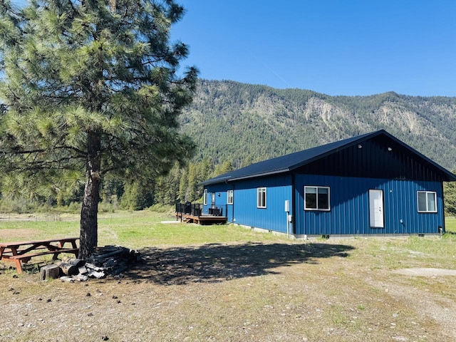 29 Shoreline Dr, Thompson Falls, MT 59873 - view of side of property featuring a deck with mountain view, crawl space, and a wooded view