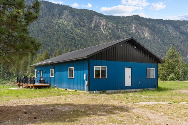 29 Shoreline Dr, Thompson Falls, MT 59873 - view of side of property featuring a deck with mountain view, a wooded view, and metal roof