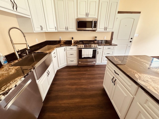 29 Shoreline Dr, Thompson Falls, MT 59873 - kitchen with appliances with stainless steel finishes, dark wood-style floors, a sink, dark stone countertops, and white cabinetry