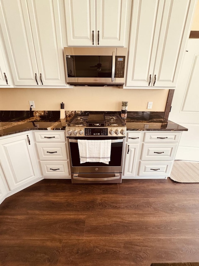 29 Shoreline Dr, Thompson Falls, MT 59873 - kitchen featuring stainless steel appliances, white cabinetry, dark wood-type flooring, and dark stone counters