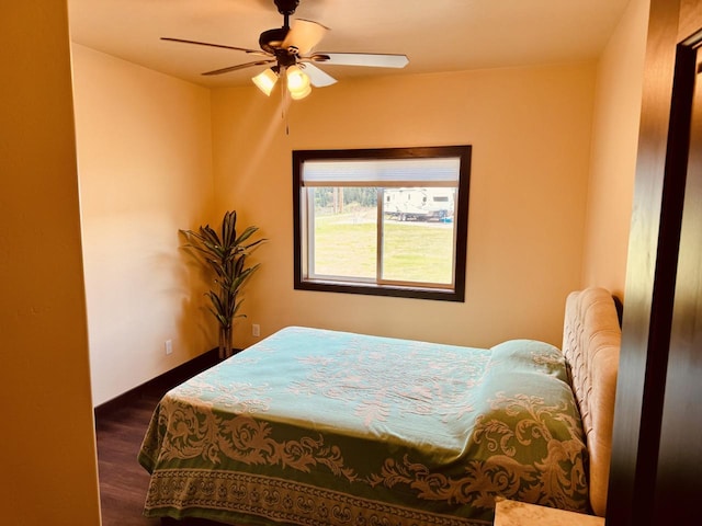29 Shoreline Dr, Thompson Falls, MT 59873 - bedroom featuring wood finished floors, a ceiling fan, and baseboards