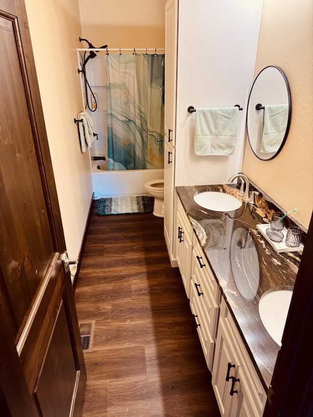 29 Shoreline Dr, Thompson Falls, MT 59873 - bathroom featuring wood finished floors, toilet, shower / tub combo, and double vanity