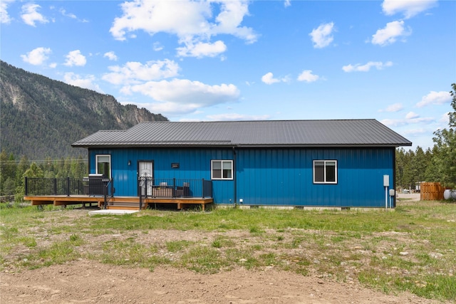 29 Shoreline Dr, Thompson Falls, MT 59873 - back of property featuring metal roof and a deck with mountain view