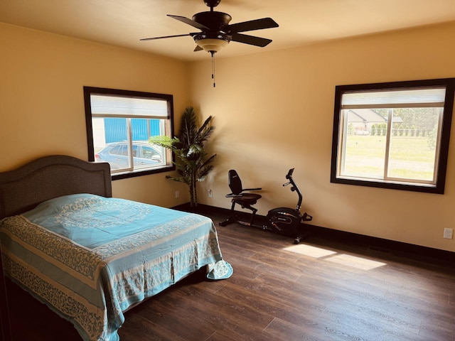 29 Shoreline Dr, Thompson Falls, MT 59873 - bedroom featuring multiple windows, dark wood-style flooring, baseboards, and a ceiling fan