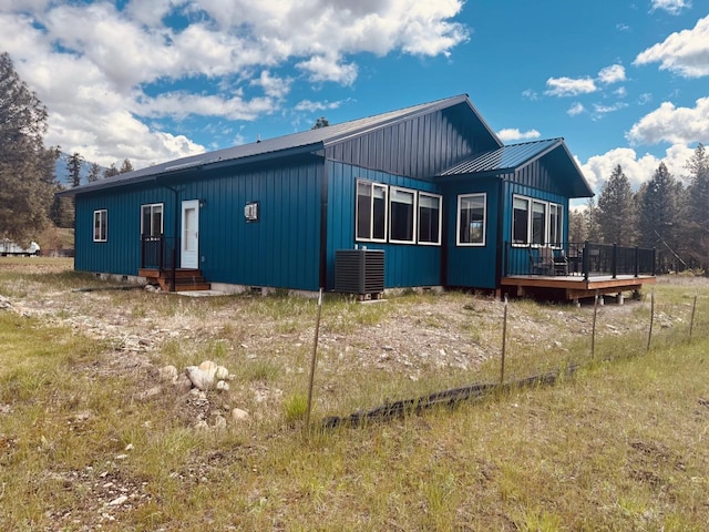 29 Shoreline Dr, Thompson Falls, MT 59873 - view of front of home featuring a deck, metal roof, board and batten siding, and central AC unit