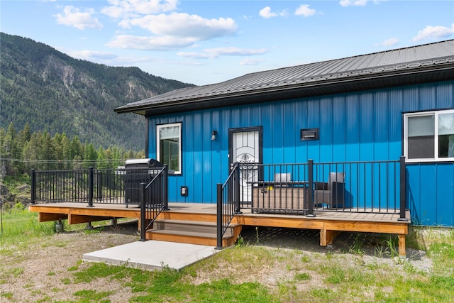29 Shoreline Dr, Thompson Falls, MT 59873 - doorway to property featuring board and batten siding, metal roof, and a deck with mountain view