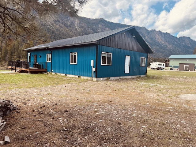 29 Shoreline Dr, Thompson Falls, MT 59873 - view of home's exterior with a deck with mountain view, metal roof, and board and batten siding
