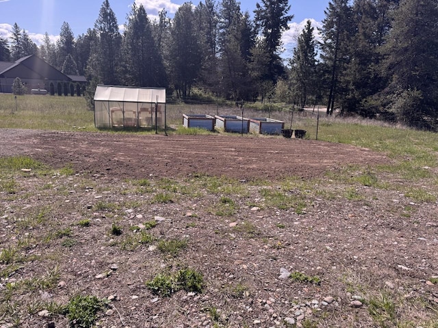 29 Shoreline Dr, Thompson Falls, MT 59873 - view of yard featuring an exterior structure, an outbuilding, a garden, and fence