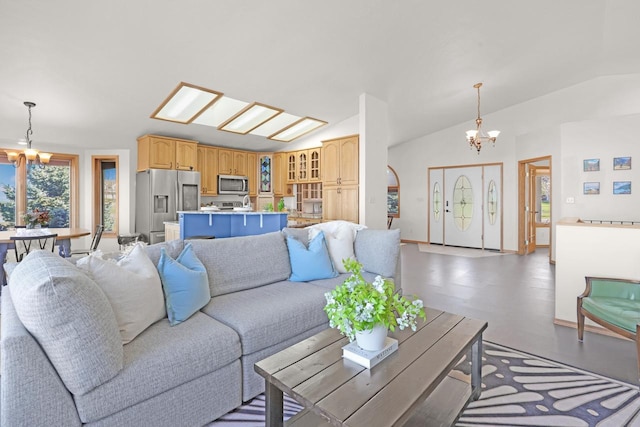 2301 Larkspur Ln, Great Falls, MT 59404 - living area featuring baseboards, a chandelier, and vaulted ceiling