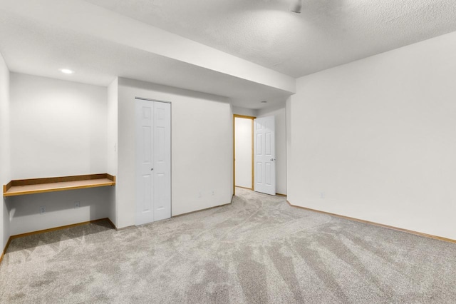 2301 Larkspur Ln, Great Falls, MT 59404 - below grade area featuring baseboards, a textured ceiling, and carpet