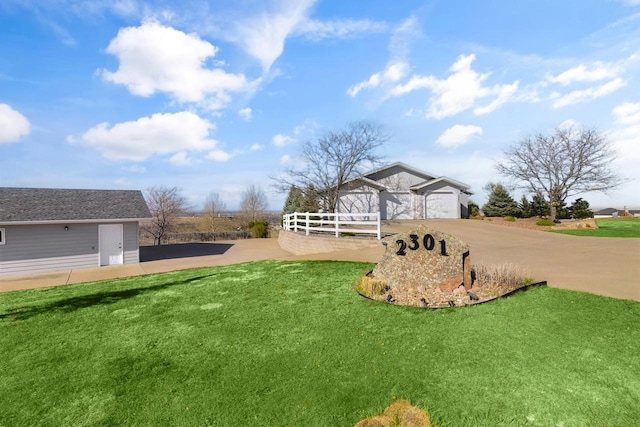 2301 Larkspur Ln, Great Falls, MT 59404 - view of yard featuring concrete driveway, fence, and a garage