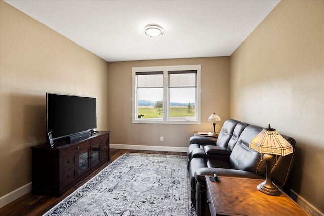 living room featuring baseboards and dark wood-style flooring