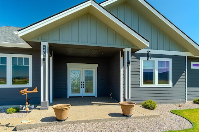 view of front of house with board and batten siding and french doors