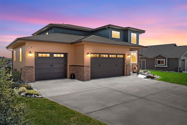 5010 Jeff Dr, Missoula, MT 59803 - view of front of property featuring a lawn, brick siding, board and batten siding, an attached garage, and driveway