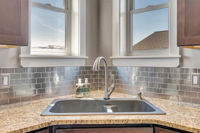 5010 Jeff Dr, Missoula, MT 59803 - interior details featuring a sink, light stone counters, tasteful backsplash, and dark brown cabinetry