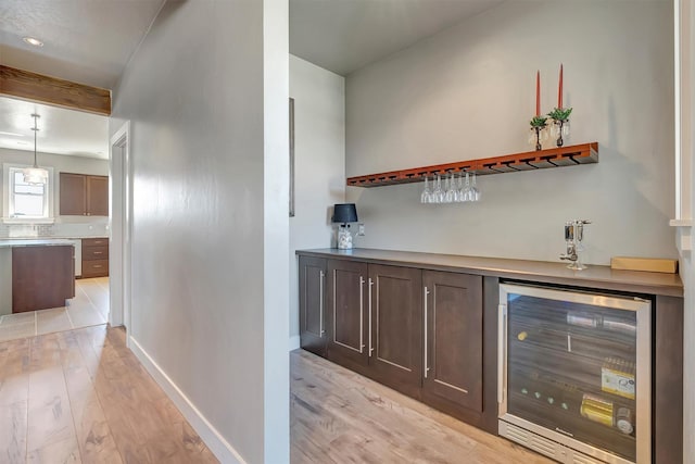 5010 Jeff Dr, Missoula, MT 59803 - bar with beverage cooler, baseboards, a dry bar, and light wood-style floors
