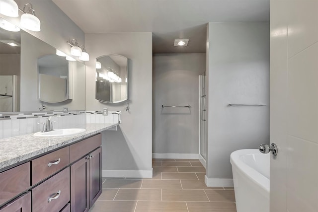 5010 Jeff Dr, Missoula, MT 59803 - full bath featuring baseboards, a freestanding bath, tile patterned floors, and vanity