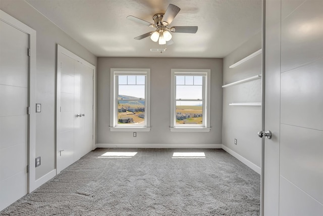5010 Jeff Dr, Missoula, MT 59803 - unfurnished bedroom with carpet floors, baseboards, a ceiling fan, and visible vents
