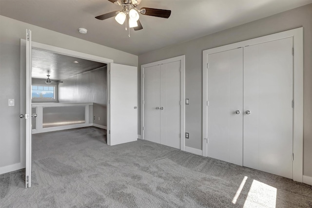 5010 Jeff Dr, Missoula, MT 59803 - unfurnished bedroom featuring multiple closets, ceiling fan, baseboards, and carpet floors