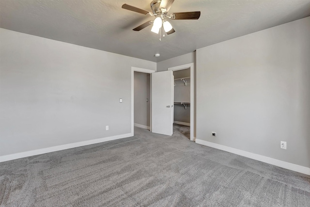 5010 Jeff Dr, Missoula, MT 59803 - unfurnished bedroom with ceiling fan, baseboards, a closet, a spacious closet, and carpet flooring