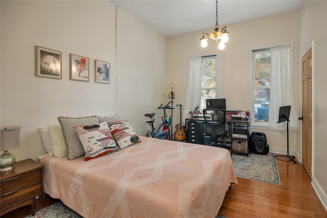 bedroom with baseboards and wood finished floors