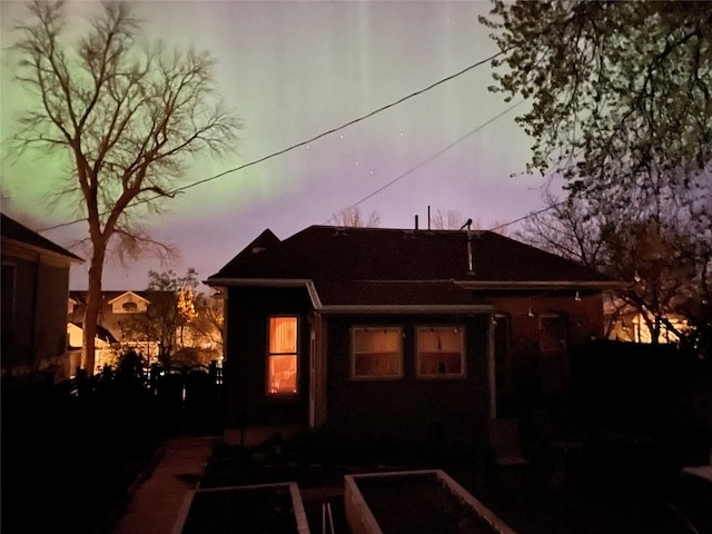 view of back of house at dusk