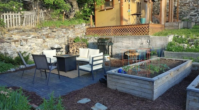 view of patio / terrace with a fire pit and fence